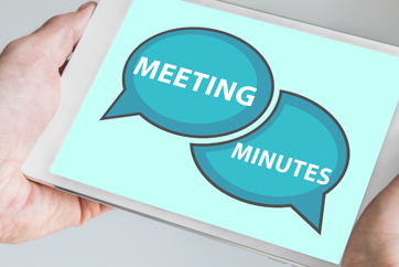 Hands holding a tablet with Meeting Minutes graphic on the screen